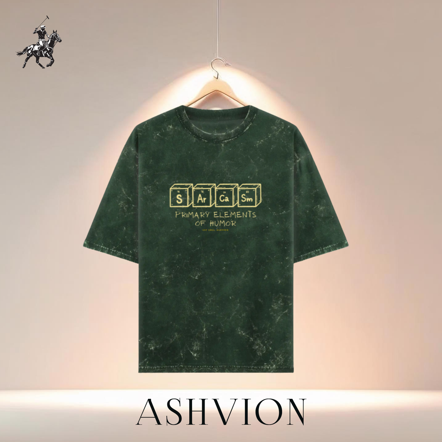 Green t-shirt with text design on a hanger against a neutral background, featuring the brand 'ASHVION'.